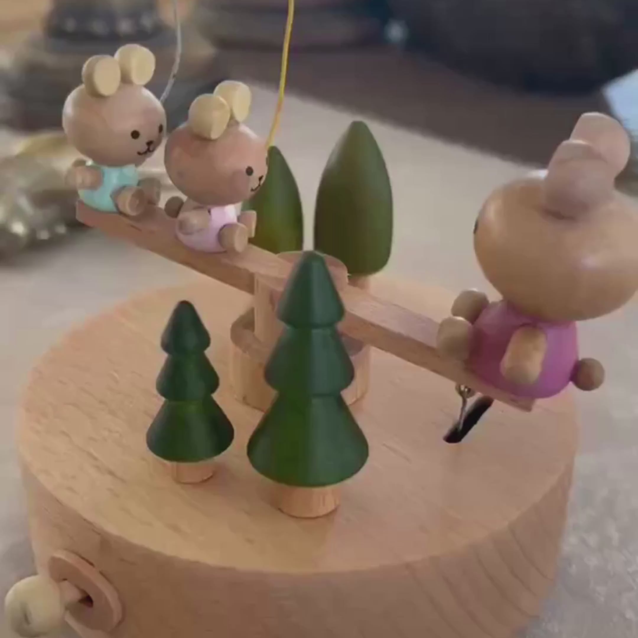 Load video: Wooden bunny family music box playing melody with moving seesaw